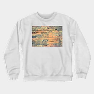 Old brick wall with cracks and scratches. Brick wall background. Distressed wall with broken bricks texture. House facade Crewneck Sweatshirt